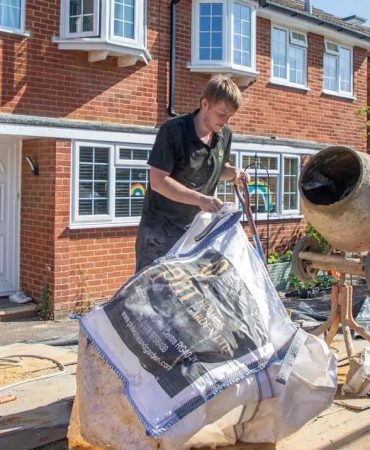 Team Member Mixing Cement