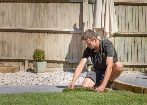 Team member laying the turf